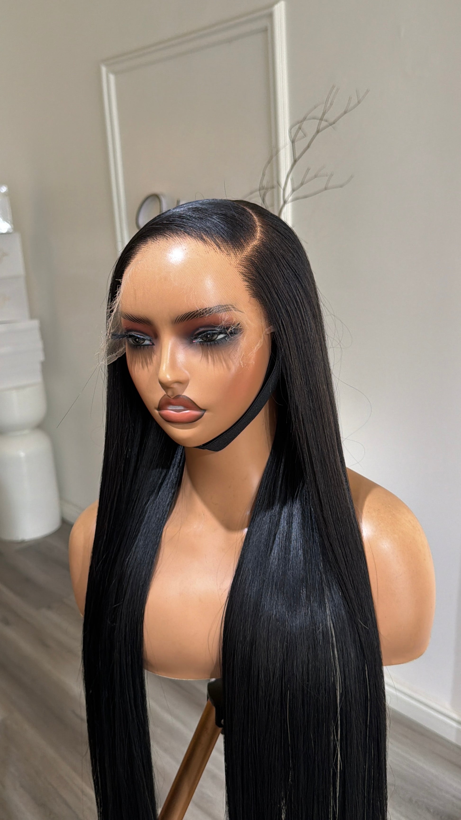 Side view of the Buss Down Midnight Black with Stripes Raw Human Hair Wig featuring a 6x6 HD lace closure, 30-inch length and silky midnight black strands with striking striped highlights and a seamless, natural-looking hairline.