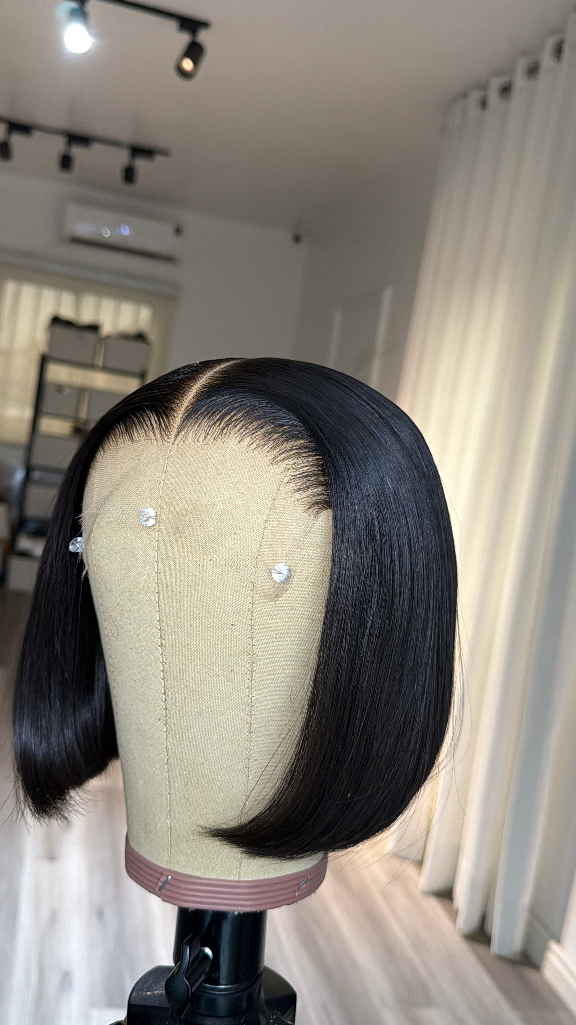 Chic Bob raw human hair wig with an HD lace closure, 8-inch bob length, sleek natural finish, front view.