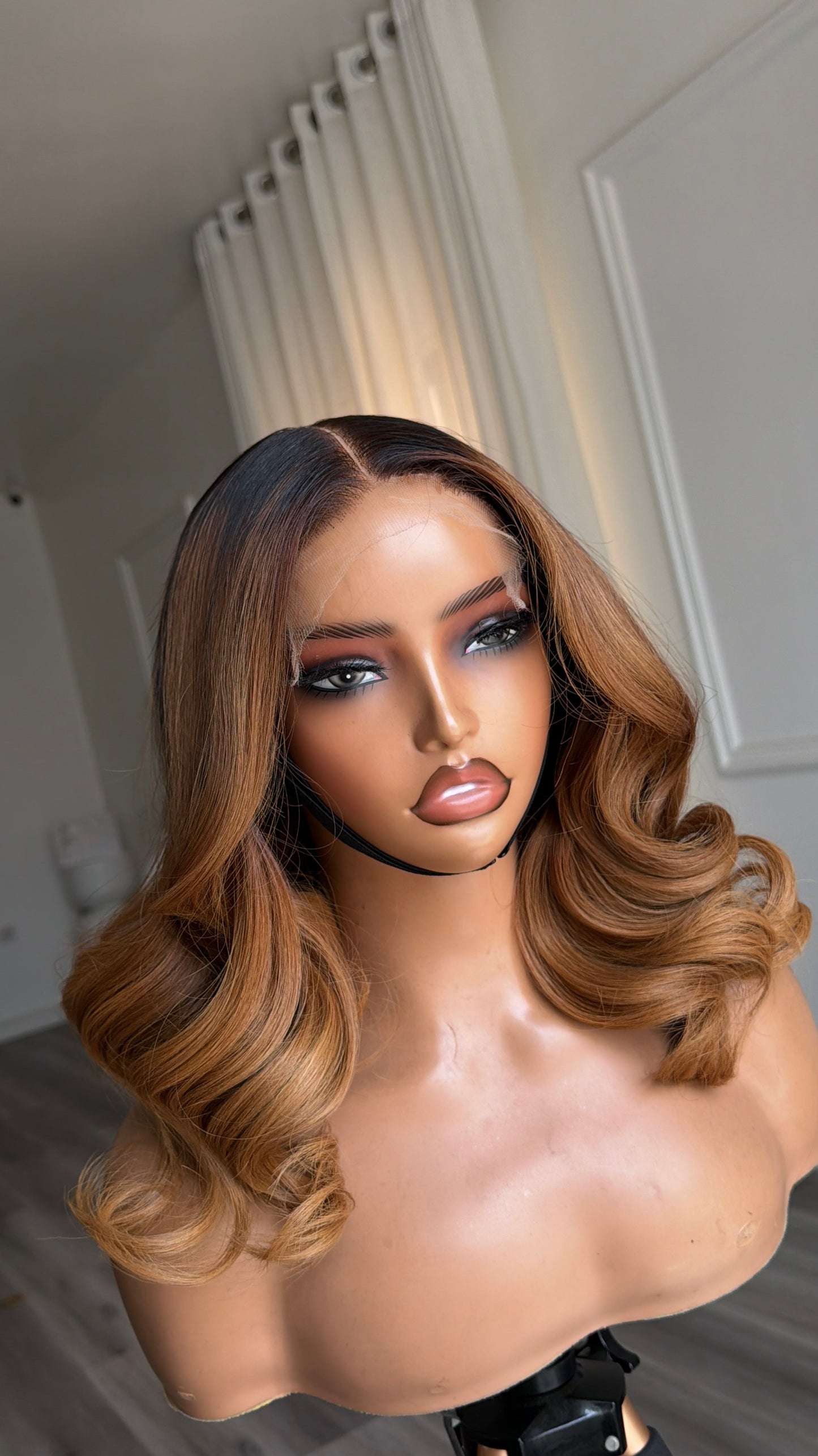 Side view of the Honey Toffee Raw Human Hair Wig featuring a 6x6 HD lace closure, 12-inch length and silky honey toffee-colored strands with a seamless, natural-looking hairline.