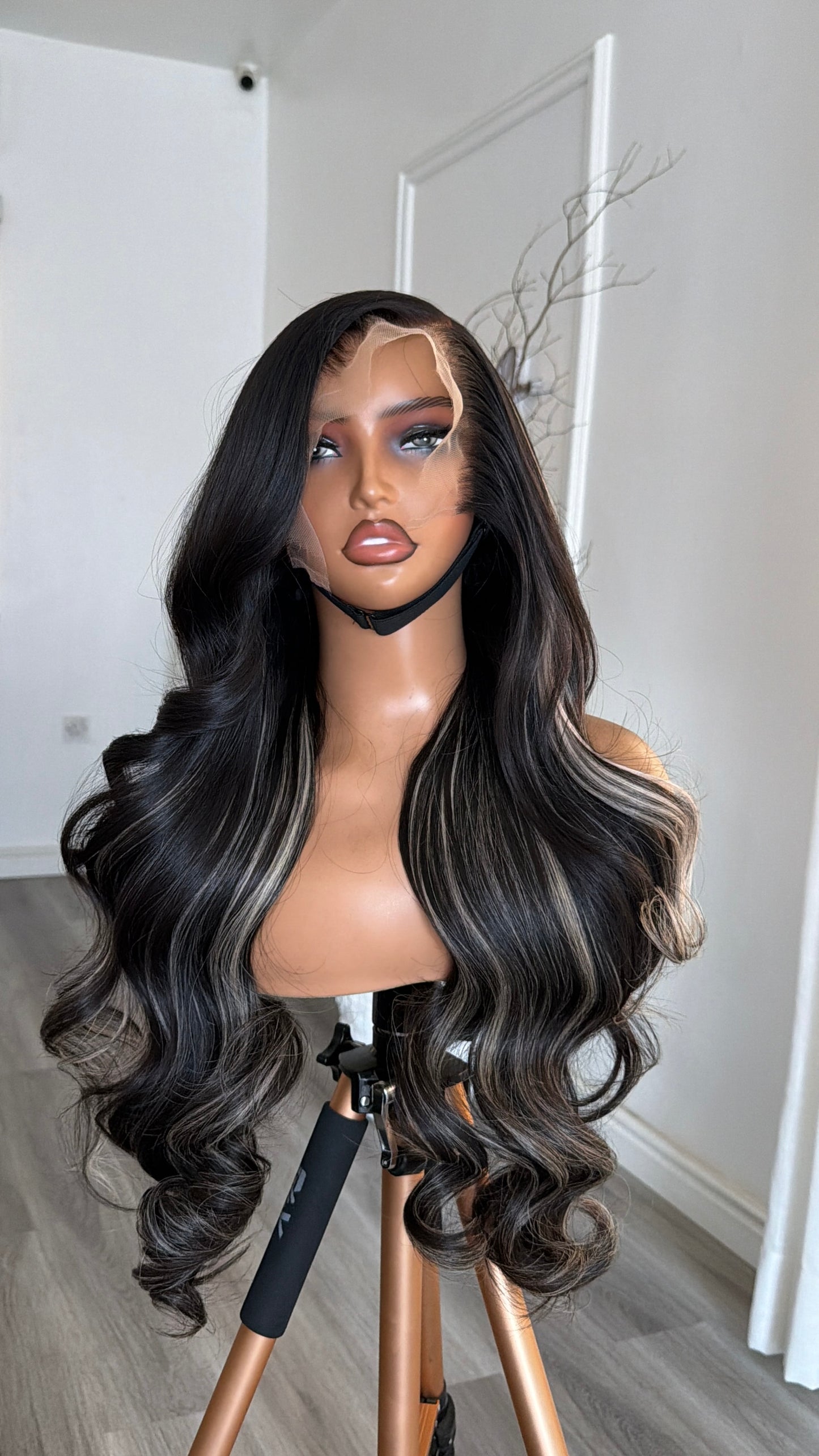 Side view of the Midnight Black Wavy Raw Human Hair Wig (Salt & Pepper) featuring a 13x6 HD lace frontal, 26-inch length and soft wavy strands with a seamless, natural-looking hairline.