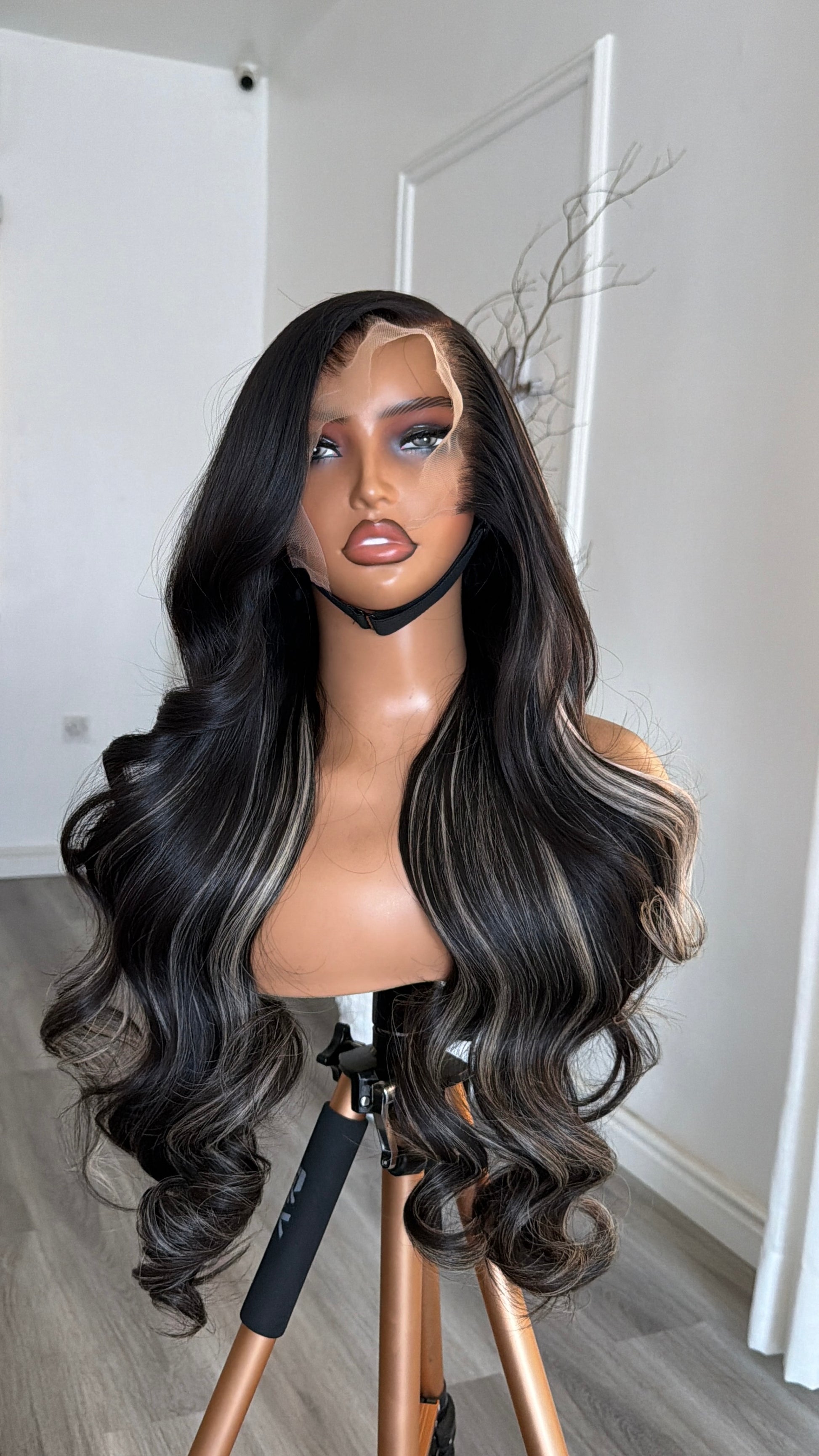 Side view of the Midnight Black Wavy Raw Human Hair Wig (Salt & Pepper) featuring a 13x6 HD lace frontal, 26-inch length and soft wavy strands with a seamless, natural-looking hairline.