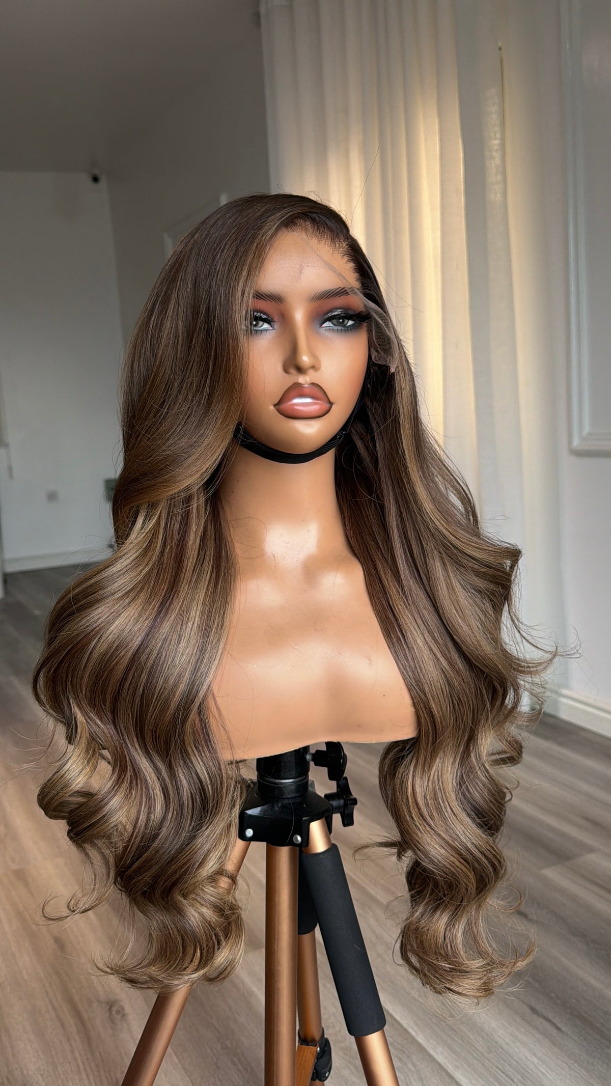 Side view of the Mocha Brunette Raw Human Hair Wig featuring a 9x6 HD lace closure, 24-inch length and silky mocha brunette strands with a seamless, natural-looking hairline.