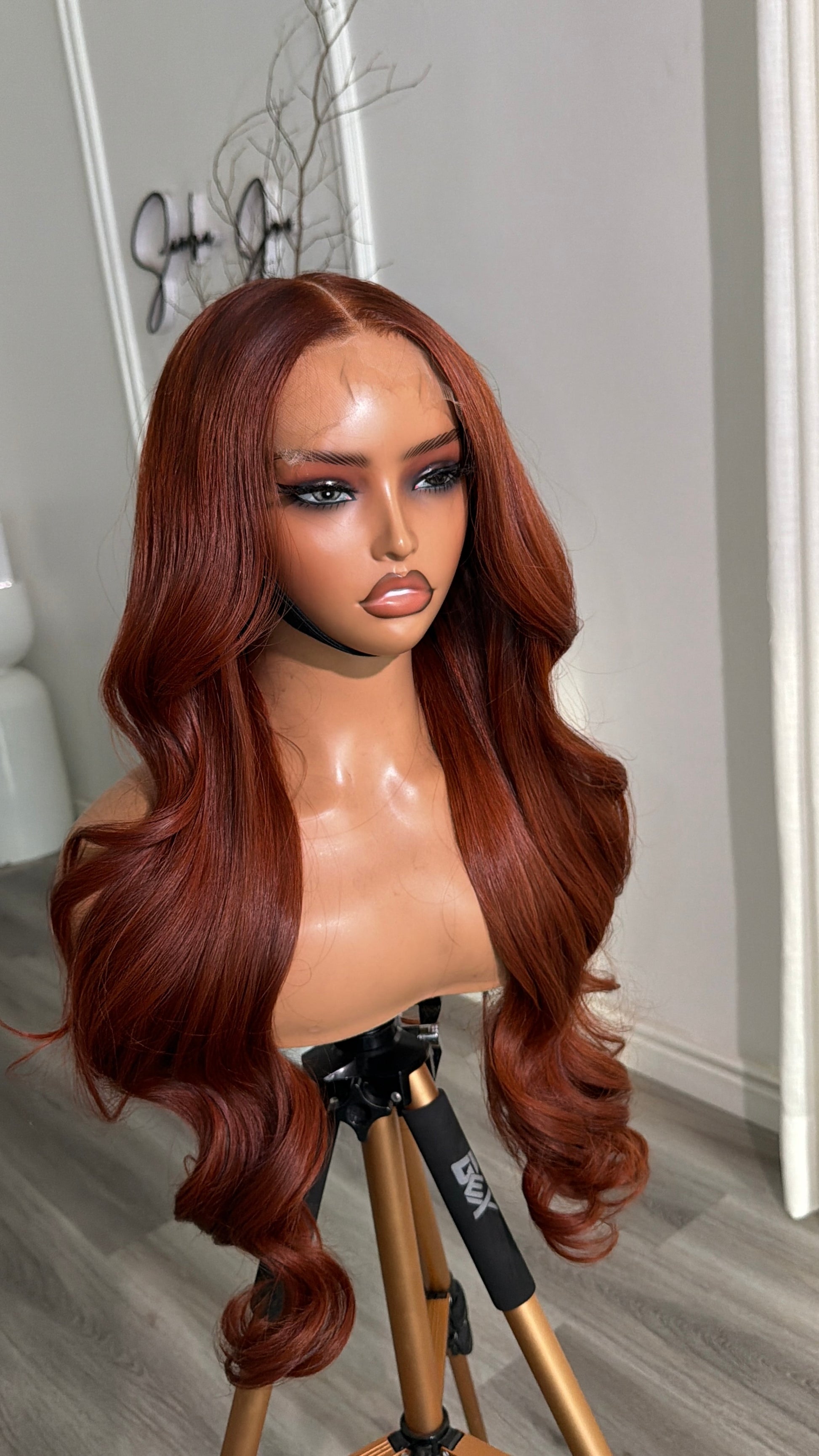 Side view of the Rich Auburn Raw Human Hair Wig featuring a 6x6 HD lace closure, 26-inch length and silky auburn strands with a seamless, natural-looking hairline.
