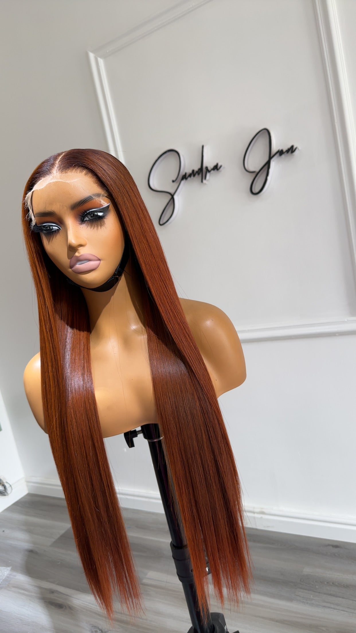 Side view of the Rich Auburn Straight Raw Human Hair Wig featuring a 6x6 HD lace closure, 24-inch length and sleek straight auburn strands with a seamless, natural-looking hairline.