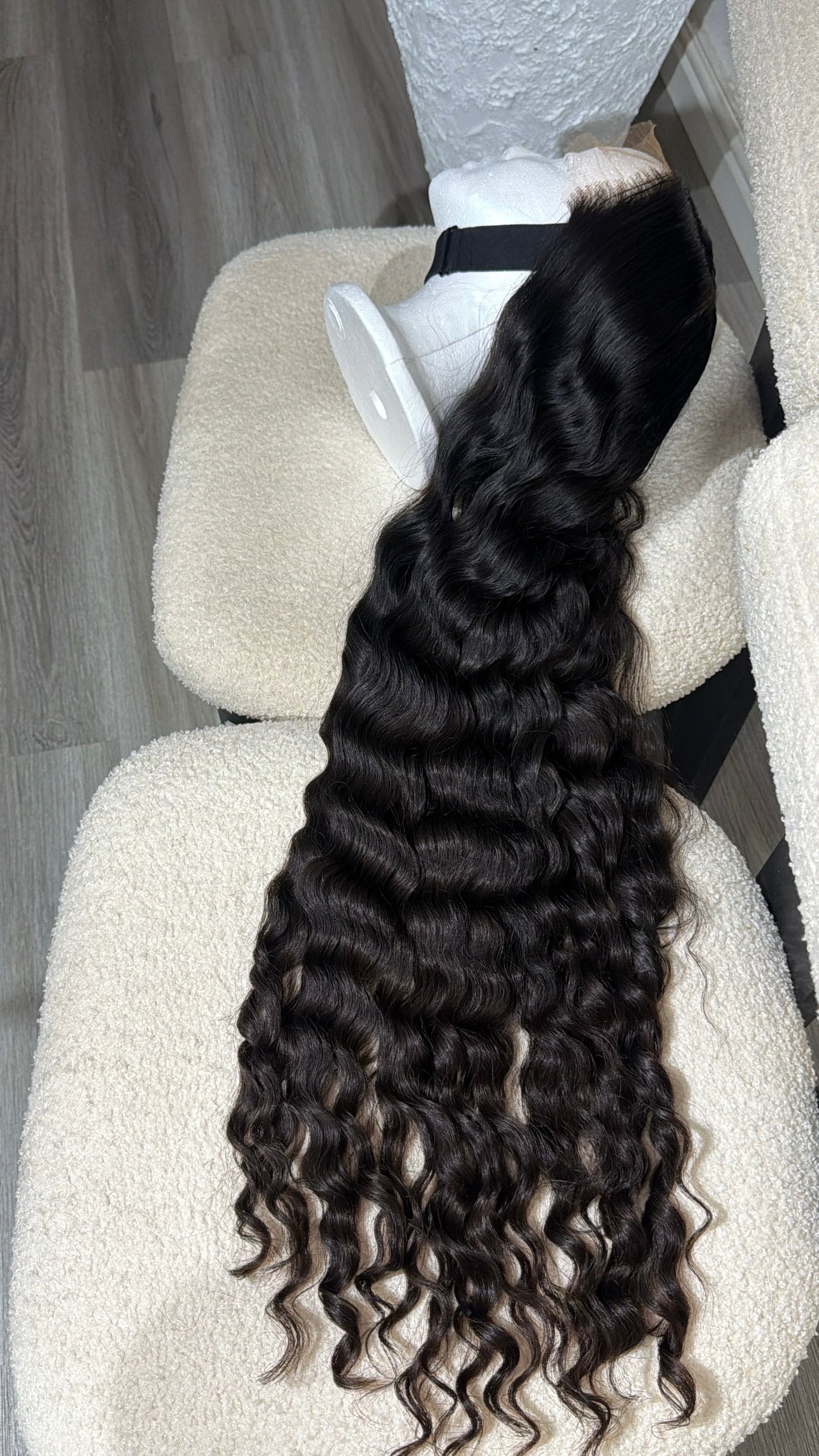 Side view of the Russian Curly raw human hair wig featuring an HD lace closure, 28–30-inch length and soft, full curly texture.