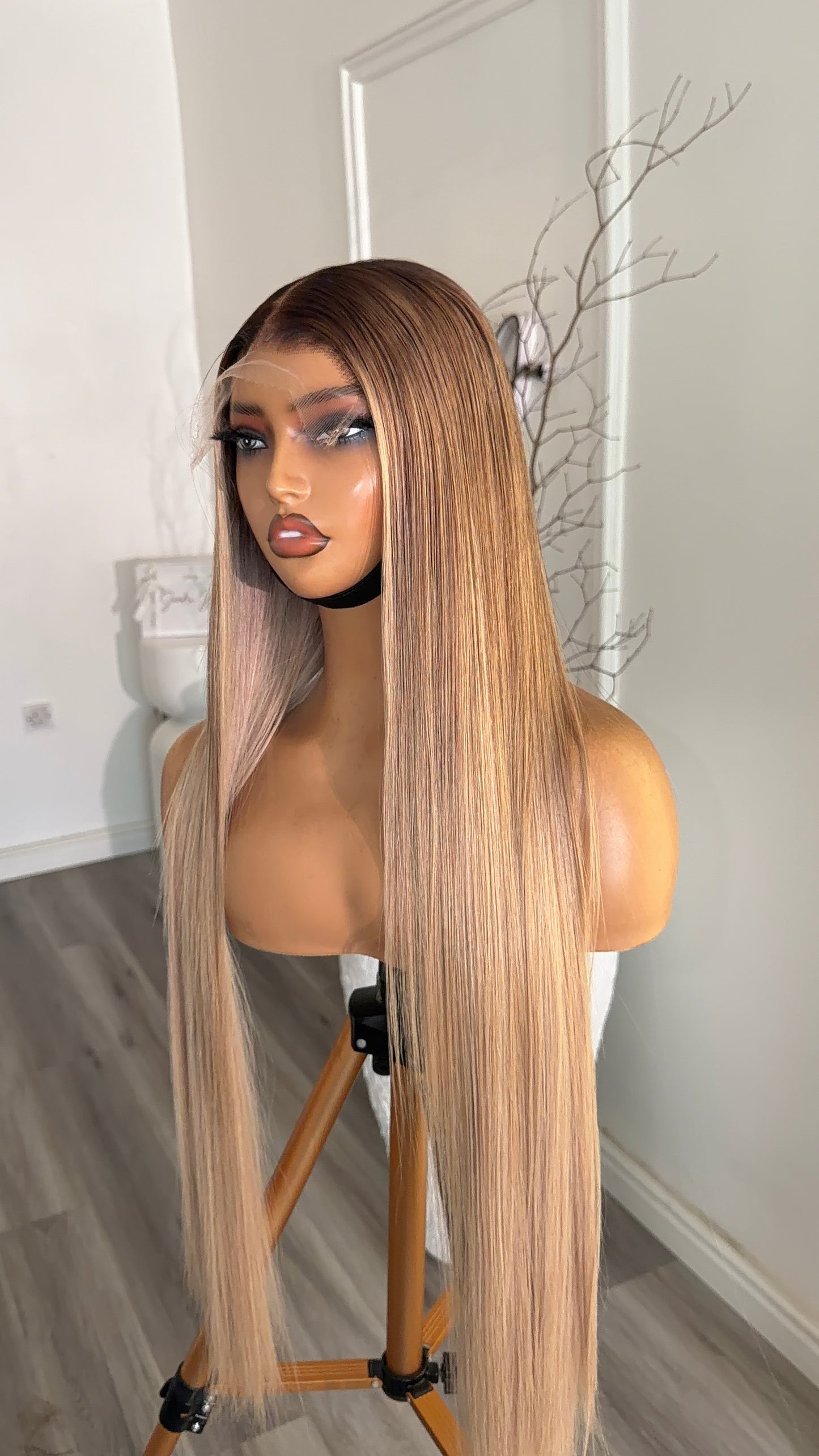 Side view of the Vanilla Beige Blonde Raw Human Hair Wig featuring a 6x6 HD lace closure, 26-inch length and silky blonde strands with a seamless, natural-looking hairline.